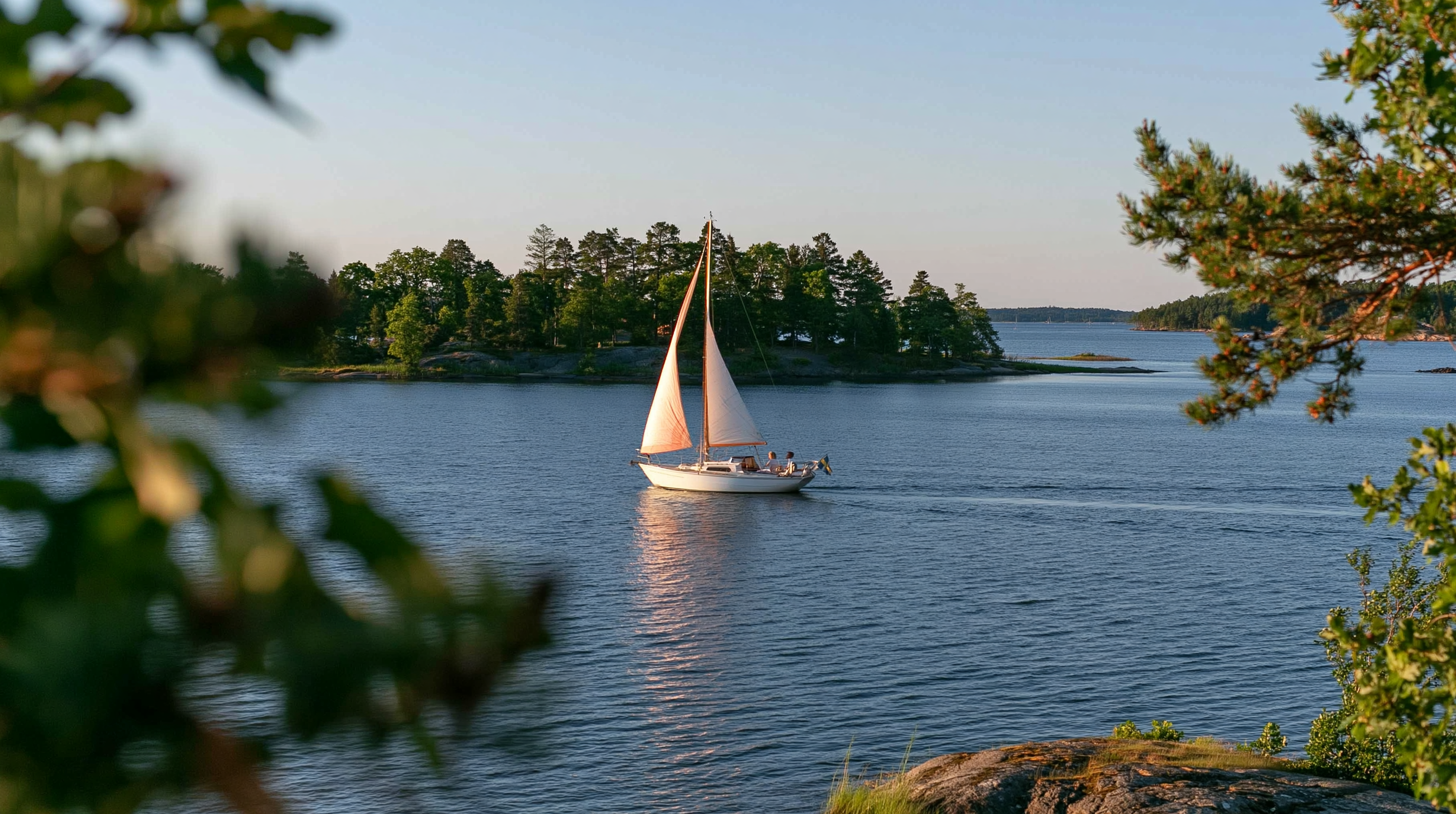 Sailboat in the archipelago, seen through trees
